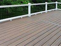 <b>Trex Transcends Spiced Rum Composite Deck with white vinyl railing and black aluminum balusters</b>